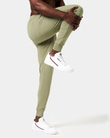 Side view of men’s green Breathe Joggers with cuffed hems, 4-way stretch fabric, and ergonomic design for unrestricted movement.