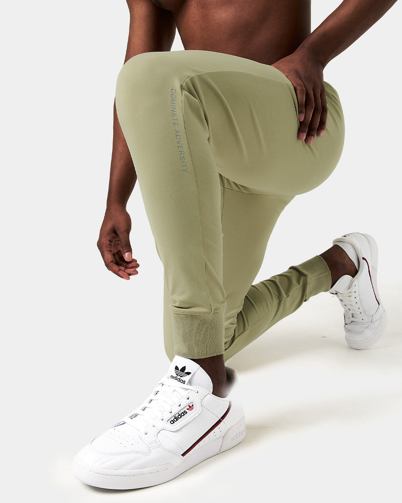 Light green sweatpants with a brand logo on a white background