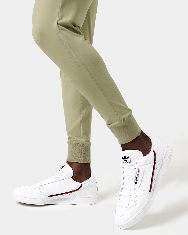 Light green sweatpants with a brand logo on a white background