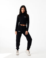 Women’s black cropped performance zip-up, designed with 4-way stretch fabric, custom zipper, and moisture-wicking properties.