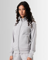Women’s light grey performance zip-up jacket, side profile showcasing breathable material and functional locking zipper pockets.