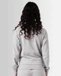 Back view of Women’s Breathe Zip-Up Jacket in light grey, with a sleek fit and reflective branding.