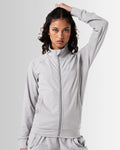 Women’s light grey Breathe Zip-Up Jacket featuring a minimalist reflective Lyftlyfe logo on the left chest and a streamlined, athletic fit.