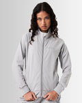 Women’s Breathe Zip-Up Jacket in light grey, designed for comfort and performance with a sleek fit and reflective branding.