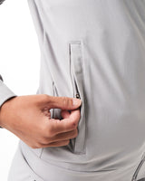 Close-up of the secure invisible pocket with locking zipper on women’s light grey Breathe Jacket, showcasing functional design and sleek finish.
