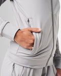Close-up of the pocket detailing on women’s athletic jacket in light grey with lightweight moisture-wicking fabric.