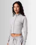 Left Side view of women’s light grey zip-up crop top, emphasizing its shaping silhouette and lightweight design for comfort.