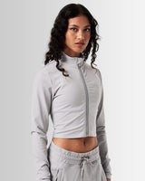 Right Side view of women’s light grey zip-up crop top, emphasizing its shaping silhouette and lightweight design for comfort.