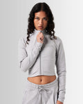 Breathe Women’s Zip-Up Crop in light grey, featuring a minimalist reflective Lyftlyfe logo on the left chest and a cropped silhouette for a flattering fit.