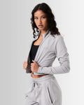 Side view of the Breathe Women’s Zip-Up Crop in light grey, highlighting the ergonomic fit, custom zipper closure, and breathable fabric.