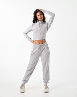 Women’s light grey cropped performance zip-up, designed with 4-way stretch fabric, custom zipper, and moisture-wicking properties.