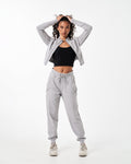 Women’s athletic crop zip-up in light grey, showcasing sleek design and tailored fit for unrestricted movement.
