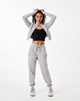 Women’s athletic crop zip-up in light grey, showcasing sleek design and tailored fit for unrestricted movement.
