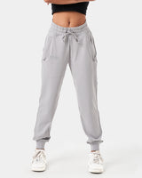 Women’s light grey joggers designed for style and performance with reflective branding and sleek, streamlined fit.