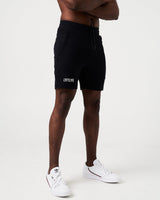 Side angle of black men’s shorts with 4-way stretch material, reflective branding, and invisible pocket detail.