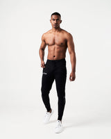 Men’s black joggers with a high-performance fabric blend and the Lyftlyfe logo near the right pocket.