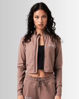 Breathe Women’s Zip-Up Crop in brown, featuring a reflective Lyftlyfe logo on the left chest and a cropped silhouette for a flattering fit.
