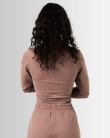 Back view of the cropped brown zip-up for women, highlighting its tailored design and lightweight construction.