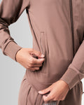 Close-up of the secure invisible pocket with locking zipper on women’s brown Breathe Jacket, showcasing functional design and sleek finish.