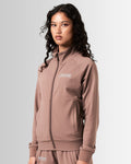 Right side view of Women's performance zip-up jacket in brown, crafted from moisture-wicking, lightweight fabric for mobility.