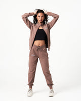 Women’s lightweight zip-up jacket in brown with moisture-wicking fabric, 4-way stretch and a reflective branding.