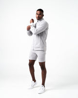 Side view of men’s light grey Breathe Zip-Up Jacket with ergonomic fit, wide cuffs, and lightweight stretch fabric for unrestricted movement.