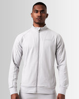 Front view of men’s light grey Breathe Zip-Up Jacket featuring a reflective Lyftlyfe logo on the left chest and a sleek, athletic fit.