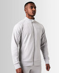 Right side view of light grey men’s athletic jacket with secure invisible pocket, locking zipper, and minimalist reflective branding.