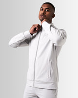 Side profile of Men’s Light Grey Breathe Zip-Up Jacket featuring a reflective Lyftlyfe logo on the left chest and a sleek, athletic fit.