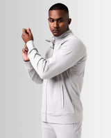 Side view of Men’s Light Grey Breathe Zip-Up Jacket featuring a reflective Lyftlyfe logo on the left chest and a sleek, athletic fit.