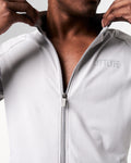 Detailed shot of the zipper design on men’s light grey performance jacket with lightweight breathable fabric.
