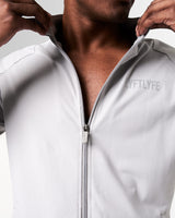 Detailed shot of the zipper design on men’s light grey performance jacket with lightweight breathable fabric.
