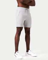 Side angle of light grey men’s shorts with 4-way stretch material, reflective branding, and invisible pocket detail.