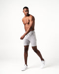 Light grey activewear shorts for men featuring sweat-wicking fabric and friction-free ergonomic design.