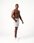 Side view of light grey men's gym shorts, featuring sweat-wicking fabric and friction-free ergonomic design.