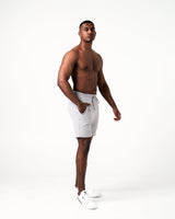 Side view of light grey men's gym shorts, featuring sweat-wicking fabric and friction-free ergonomic design.