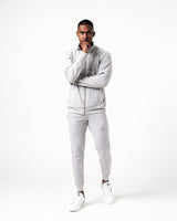 Men’s light grey joggers with a high-performance fabric blend and the Lyftlyfe logo near the right pocket.