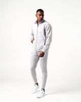 Side angle of light grey men’s athletic jacket with secure invisible pocket, locking zipper, and minimalist reflective branding.