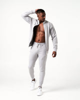 Men’s Breathe Zip-Up Jacket in light grey featuring a reflective Lyftlyfe logo on the left chest and a sleek, athletic fit.