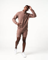 Men’s lightweight zip-up jacket in brown with moisture-wicking fabric, 4-way stretch, and ergonomic design for optimal performance.