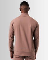 Back view of men’s brown Breathe Zip-Up Jacket with ergonomic construction, lightweight breathable fabric, and seamless design.