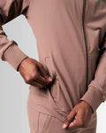 Detailed view of the neck and custom zipper construction on men’s sleek brown zip-up jacket.