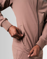 Detailed view of the neck and custom zipper construction on men’s sleek brown zip-up jacket.