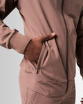 Close-up of the secure pocket with locking zipper on men’s brown Breathe Jacket, showcasing functional design and sleek finish.