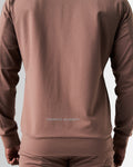 Back view of the men’s Breathe Zip-Up Jacket in brown, featuring the 'Dominate Adversity' slogan printed at the lower back.