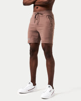 Side view of brown activewear shorts for men featuring sweat-wicking fabric and friction-free ergonomic design.