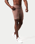 Close-up of the secure invisible pocket with locking zipper on men’s brown lightweight performance shorts.