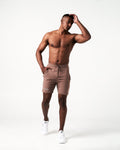 Men's Breathe Shorts in brown featuring a minimalist reflective Lyftlyfe logo, wide waistband, and adjustable tonal drawstring.
