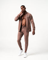 Men’s Breathe Zip-Up Jacket in brown featuring a reflective Lyftlyfe logo on the left chest and a sleek, athletic fit.