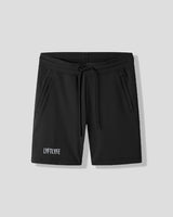 Black shorts with a brand logo on a light gray background